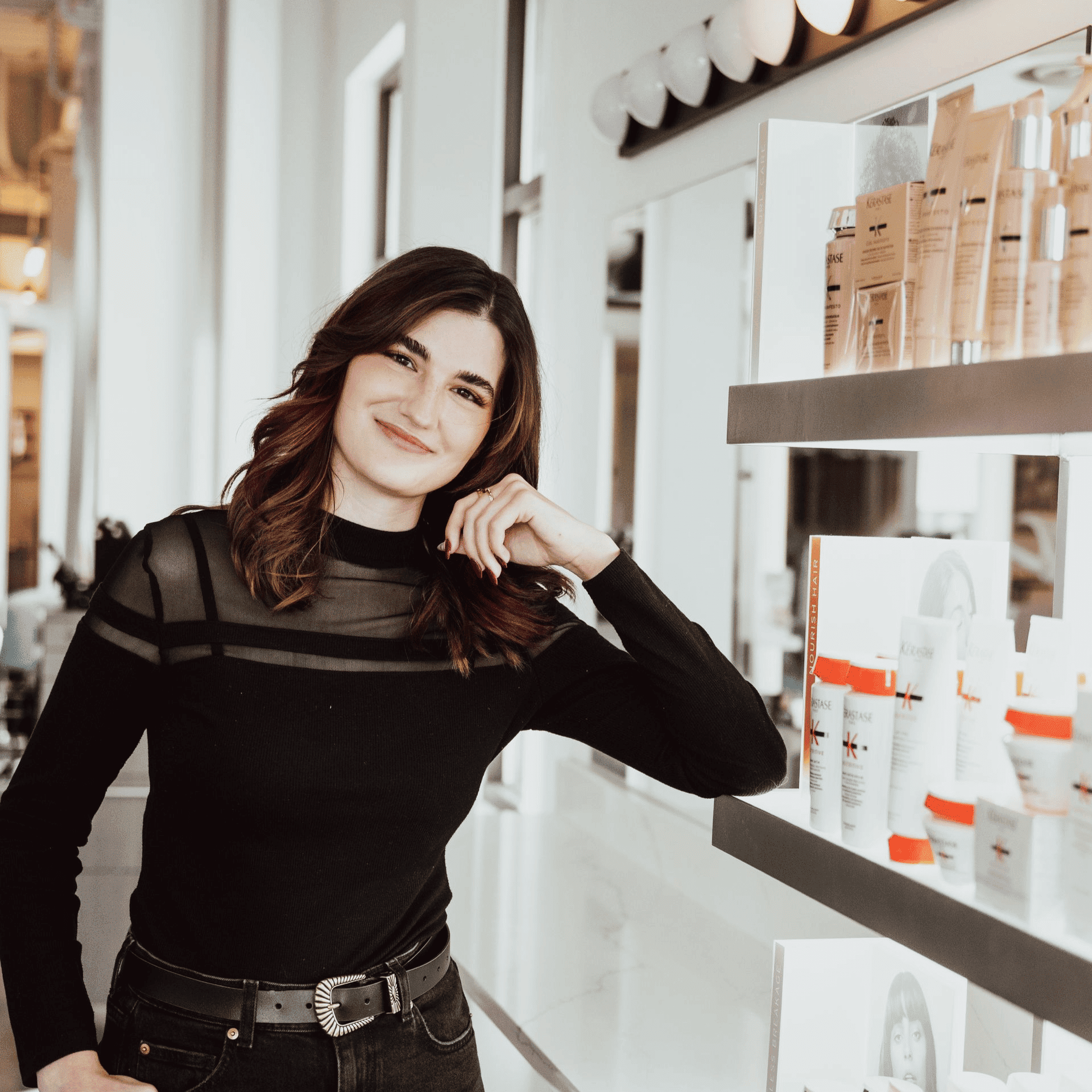 Portrait of Elle, a professional stylist at Ottalaus Salon, showcasing their expertise and style.