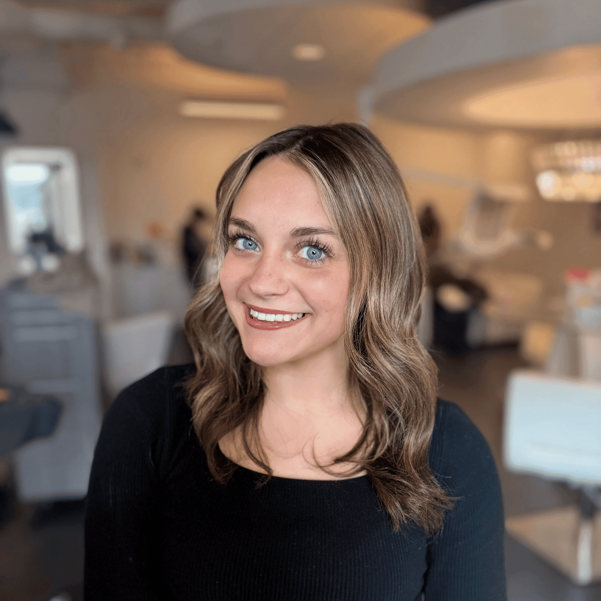 Portrait of Carlie Southwick, a professional stylist at Ottalaus Salon, showcasing their expertise and style.