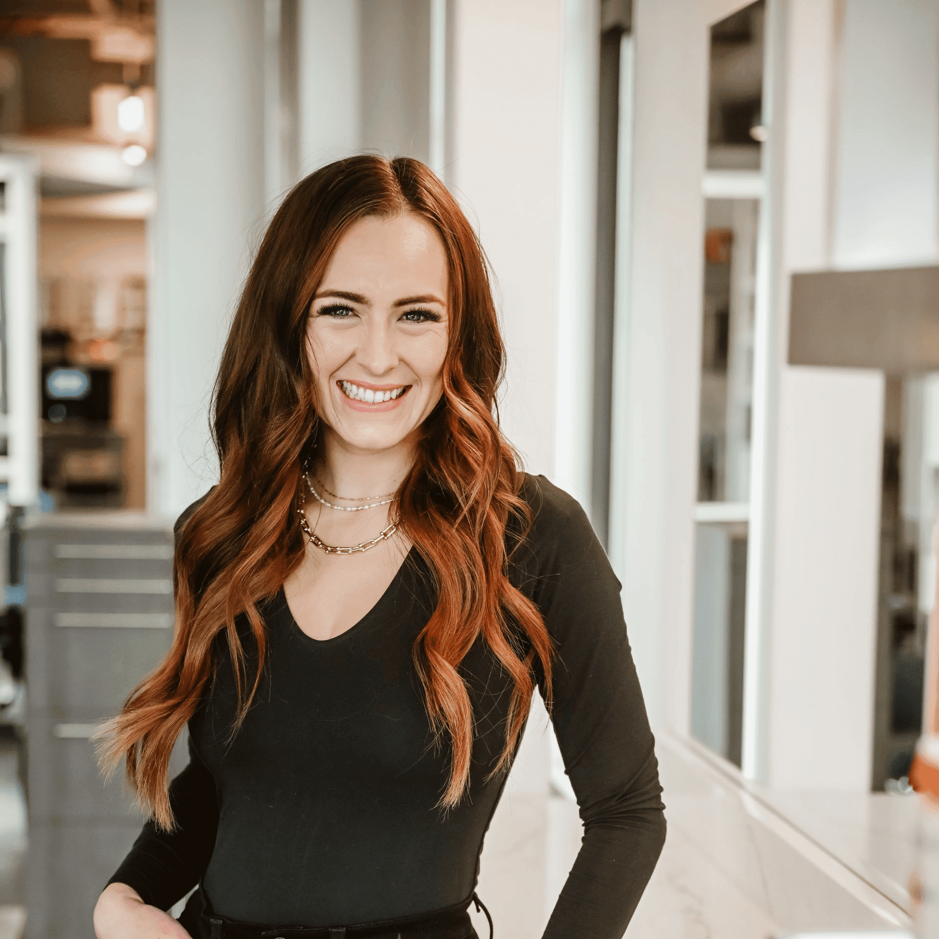 Portrait of Aly, a professional stylist at Ottalaus Salon, showcasing their expertise and style.