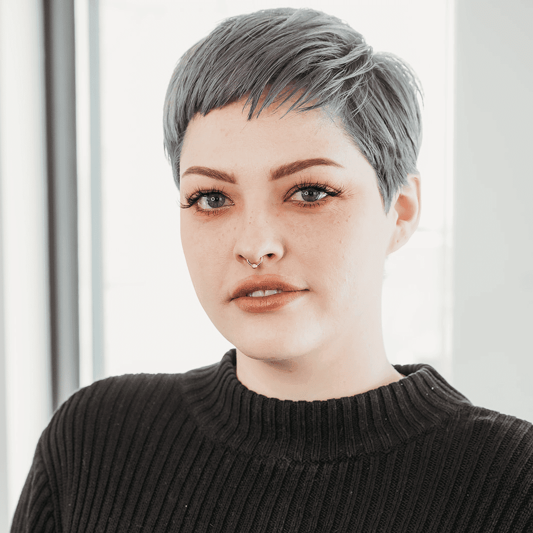 Portrait of Eliza, a professional stylist at Ottalaus Salon, showcasing their expertise and style.