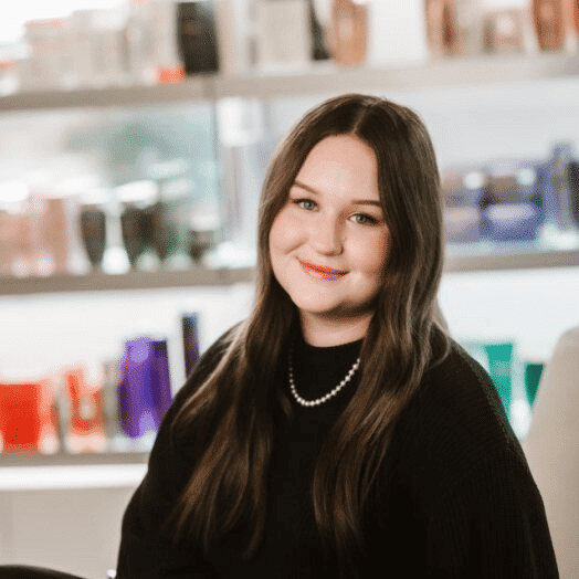 Portrait of Maci, a professional stylist at Ottalaus Salon, showcasing their expertise and style.