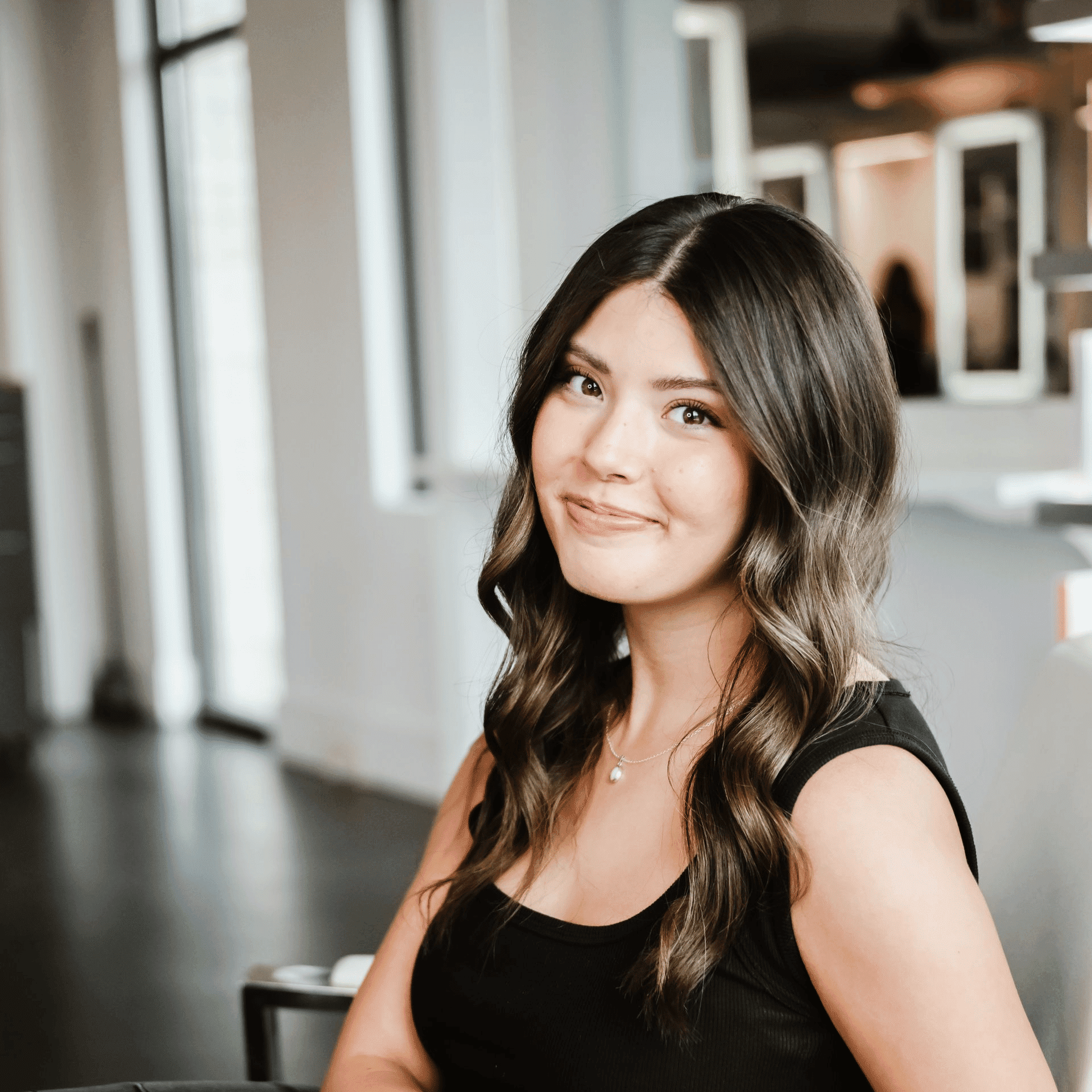 Portrait of Jamie, a professional stylist at Ottalaus Salon, showcasing their expertise and style.