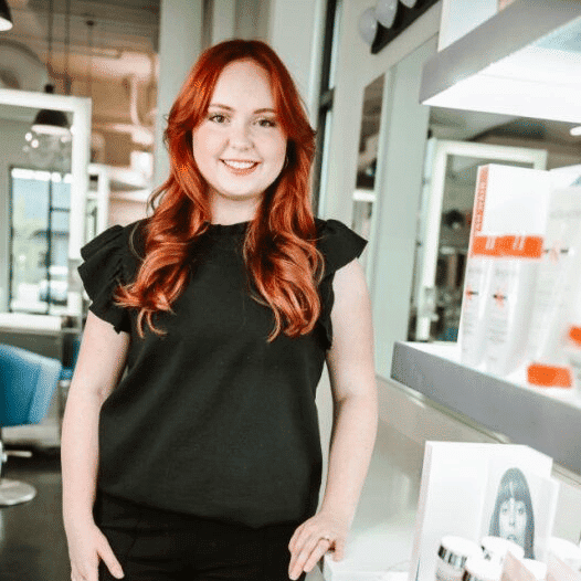 Portrait of Kylie, a professional stylist at Ottalaus Salon, showcasing their expertise and style.