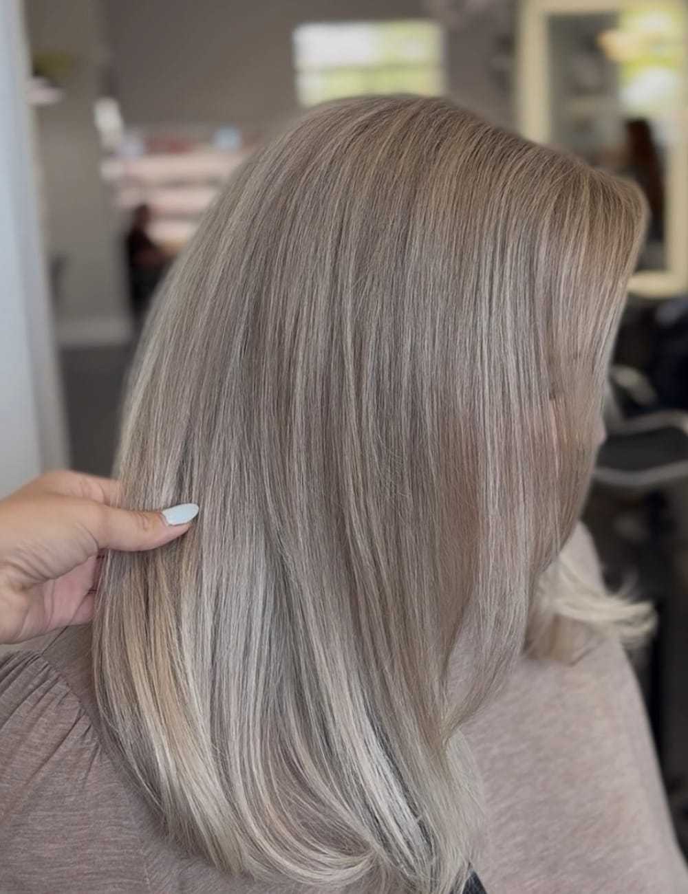 Blonde hair with highlights shown in a salon setting.