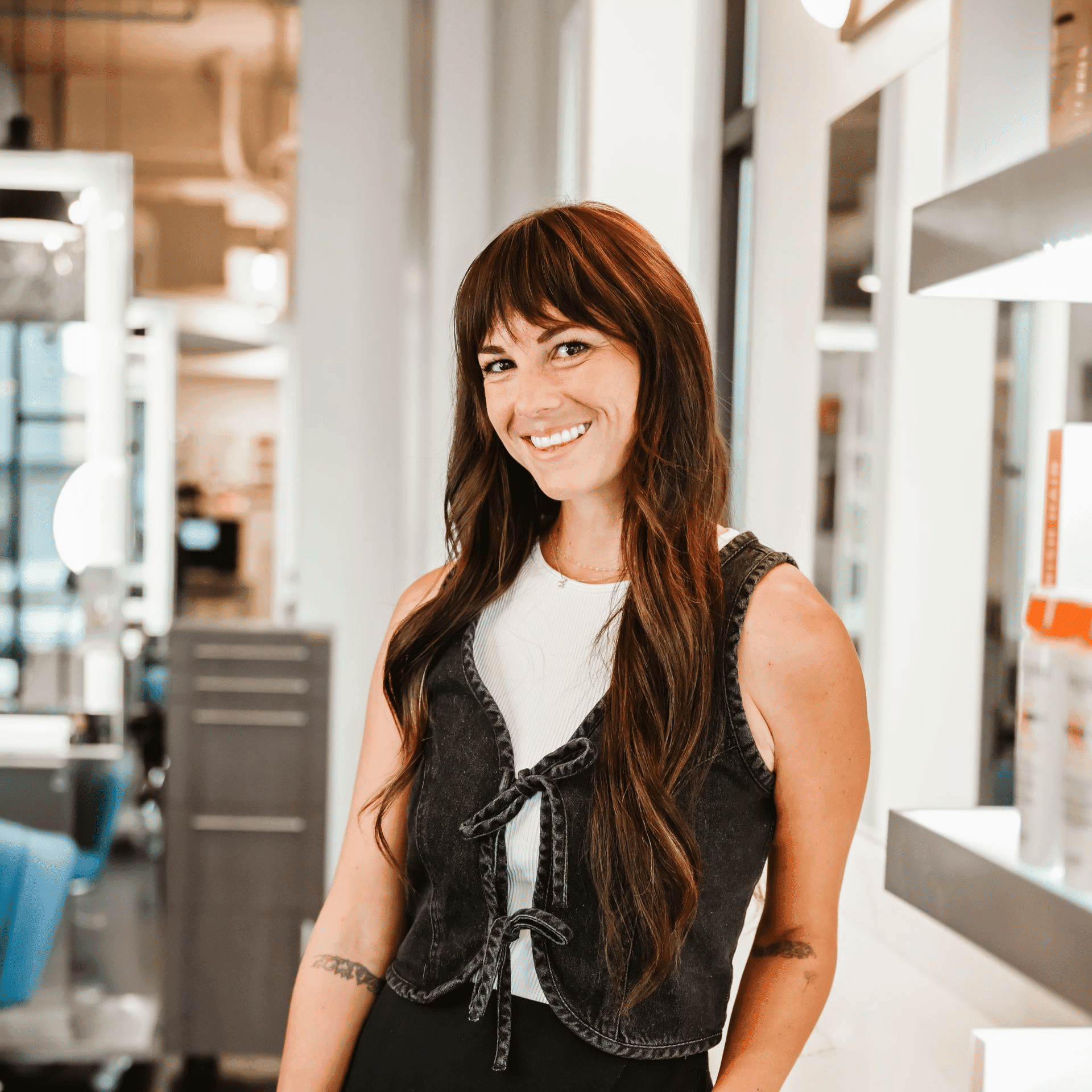 Portrait of Charli, a professional stylist at Ottalaus Salon, showcasing their expertise and style.