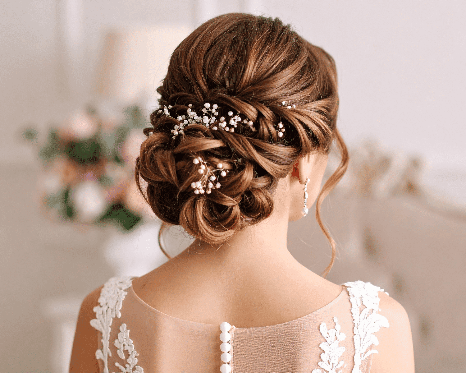 Elegant bridal updo with intricate braids and pearl accents.