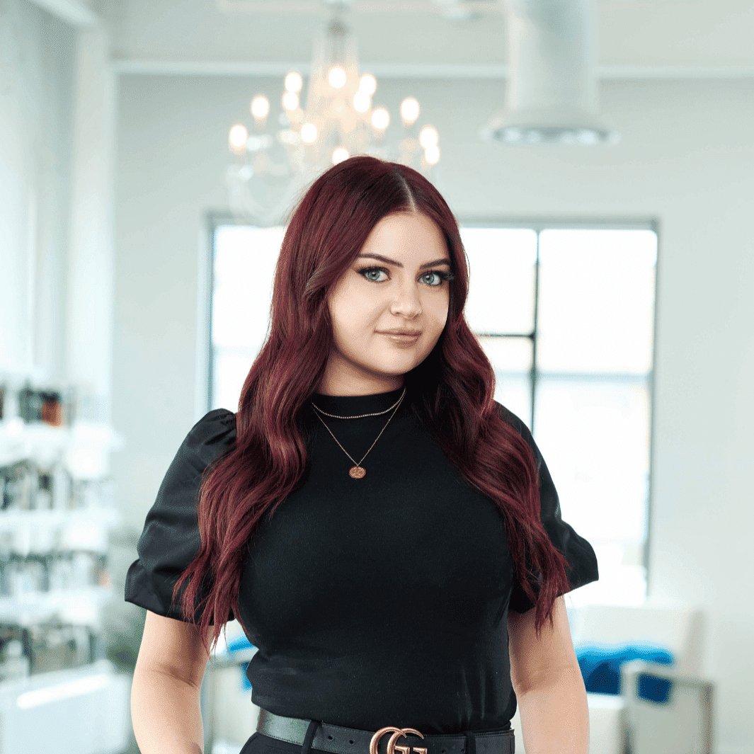 Portrait of Kailey, a professional stylist at Ottalaus Salon, showcasing their expertise and style.