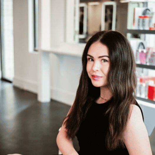 Portrait of Kinsie, a professional stylist at Ottalaus Salon, showcasing their expertise and style.