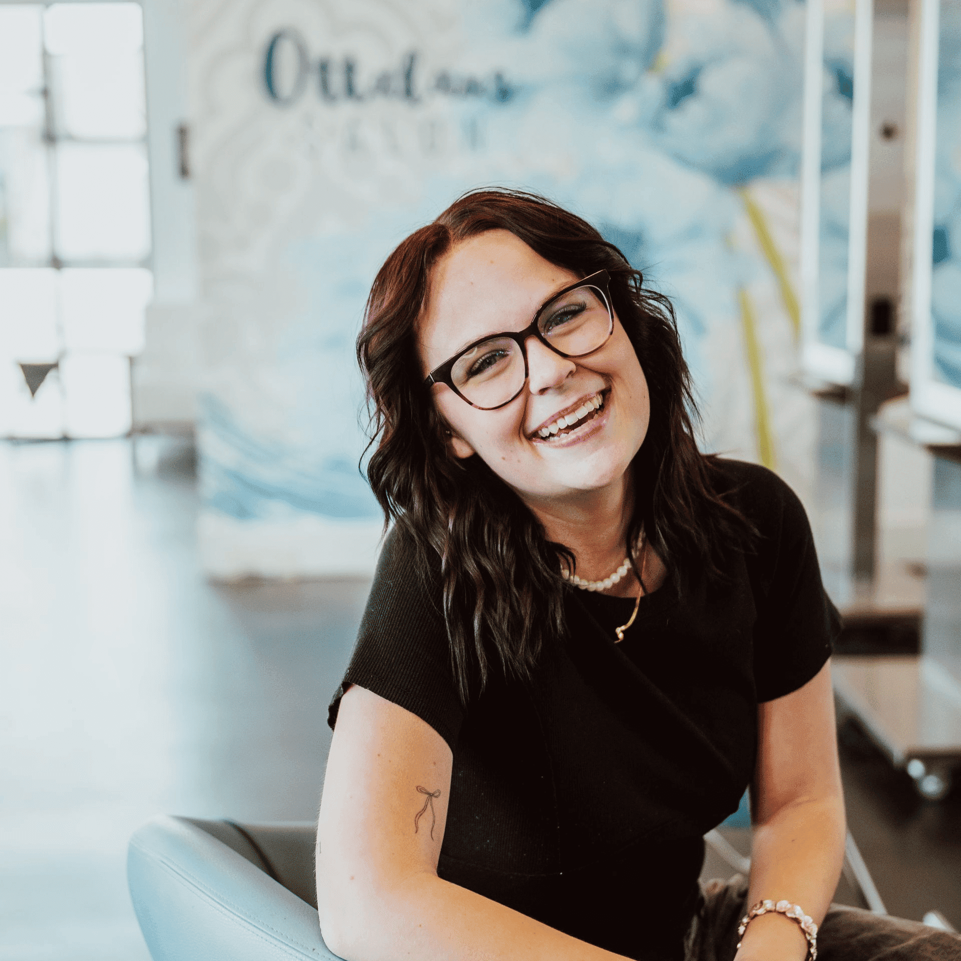 Portrait of Ashlyn, a professional stylist at Ottalaus Salon, showcasing their expertise and style.