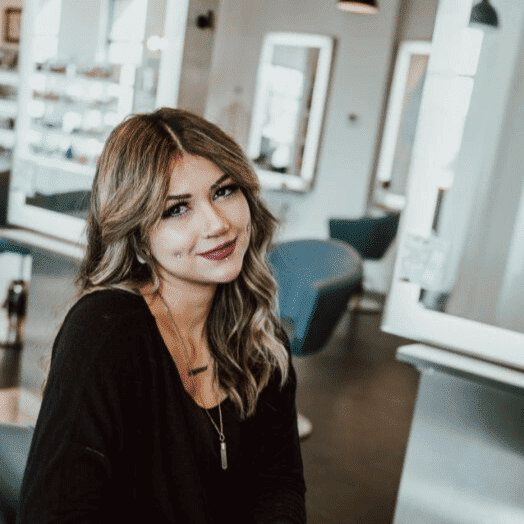 Portrait of Mellie, a professional stylist at Ottalaus Salon, showcasing their expertise and style.