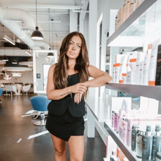 Portrait of Kaity, a professional stylist at Ottalaus Salon, showcasing their expertise and style.